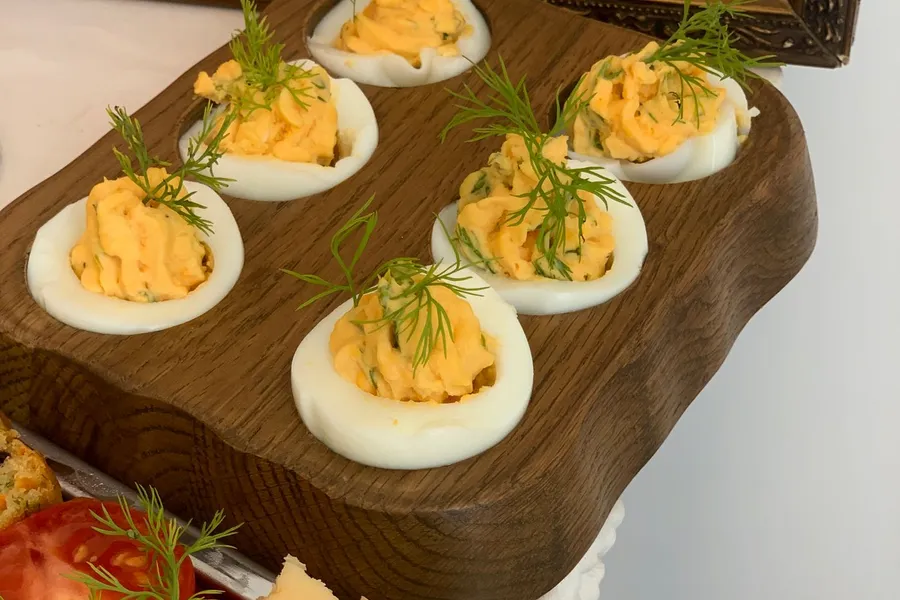 Close-up of deviled eggs garnished with herbs on a platter