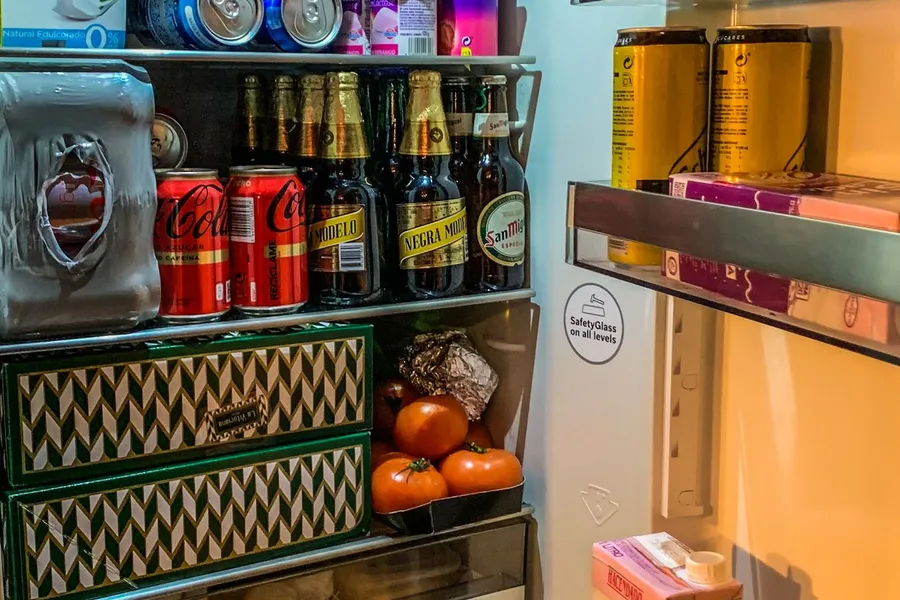 Open refrigerator with organized groceries and food containers