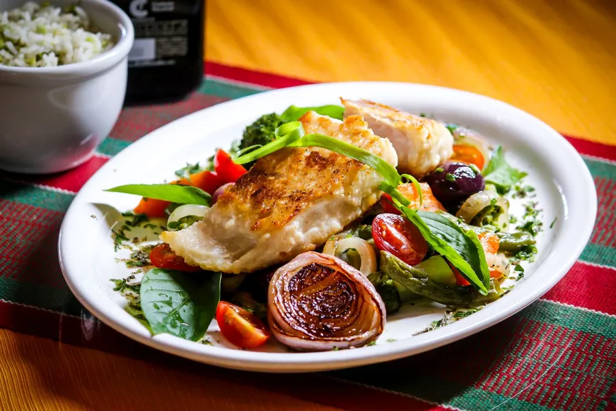 Grilled chicken with vegetables on a white plate