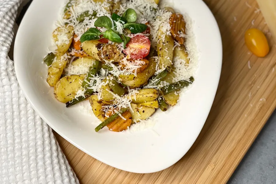 Gnocchi with vegetables and parmesan on a plate